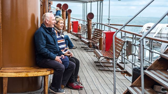 A couple enjoy a the view from the P.S Waverly steam ship